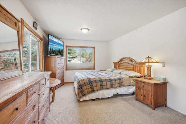 carpeted bedroom featuring a textured ceiling