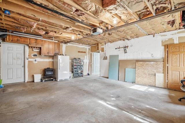 garage with white fridge and a garage door opener