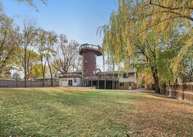 rear view of property featuring a yard and a deck