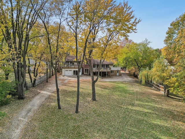 view of front of house featuring a front yard, a garage, and a wooden deck