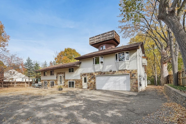 rear view of property featuring a garage