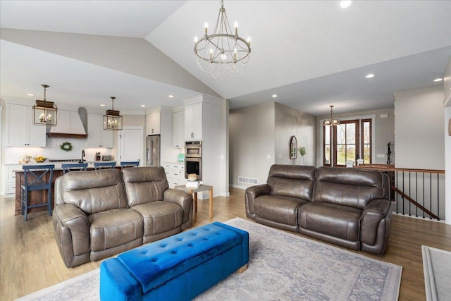 living room featuring lofted ceiling and light wood-type flooring