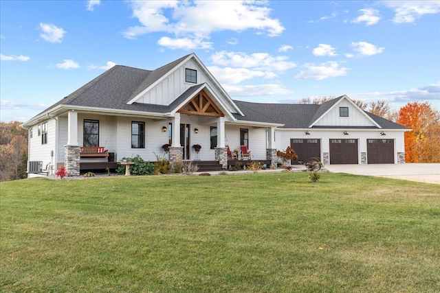 craftsman-style home with a front yard, a garage, covered porch, and central AC unit