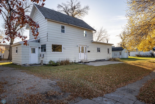 back of property featuring a patio and a lawn