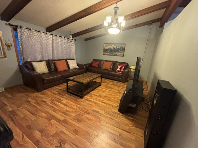 living room featuring beam ceiling, light hardwood / wood-style flooring, and a chandelier