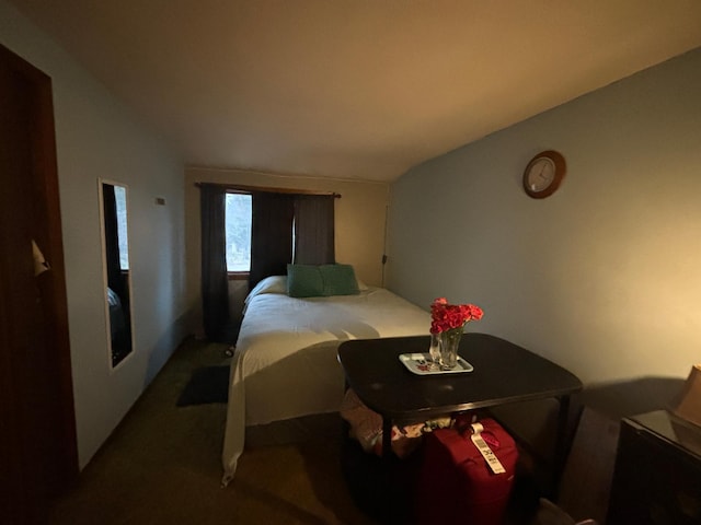 carpeted bedroom with vaulted ceiling