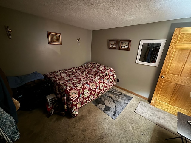 bedroom with a textured ceiling and carpet floors