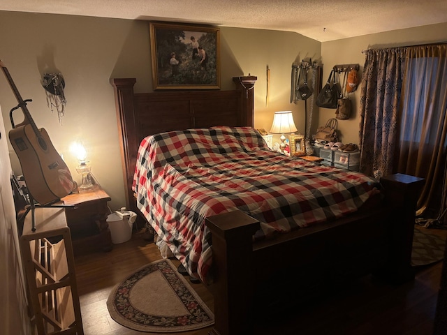 bedroom featuring a textured ceiling and hardwood / wood-style flooring