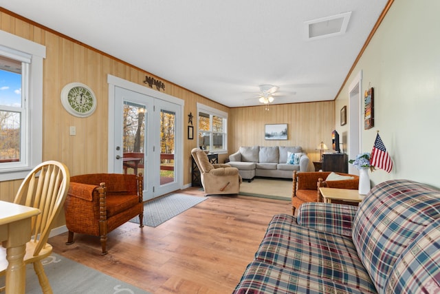 37760 310th St, Aitkin, MN 56431 - living room with crown molding, light wood finished floors, a ceiling fan, wood walls, and baseboards