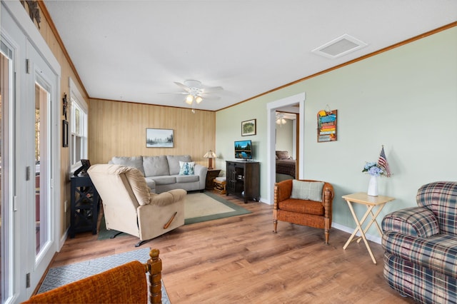 37760 310th St, Aitkin, MN 56431 - living area featuring crown molding, light wood-type flooring, baseboards, and a ceiling fan