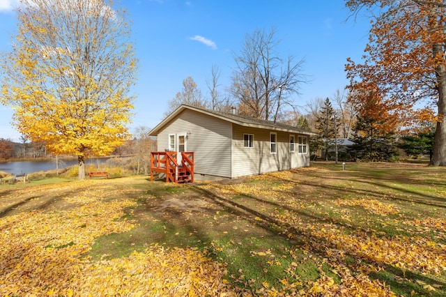 37760 310th St, Aitkin, MN 56431 - view of side of property featuring a water view, a lawn, and crawl space