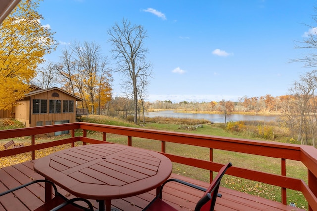 37760 310th St, Aitkin, MN 56431 - deck with a water view, an outbuilding, and outdoor dining space