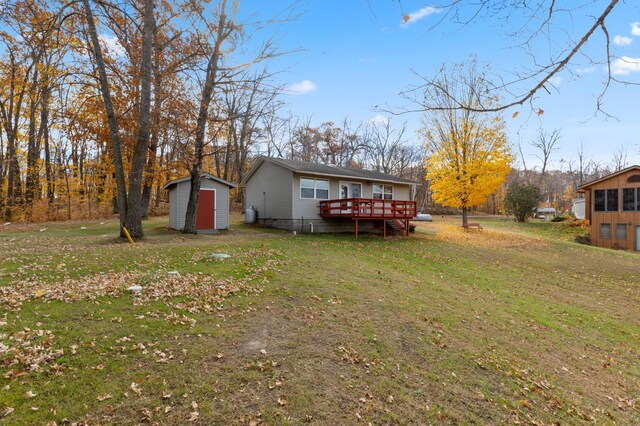 37760 310th St, Aitkin, MN 56431 - view of green lawn with a wooden deck and a storage unit
