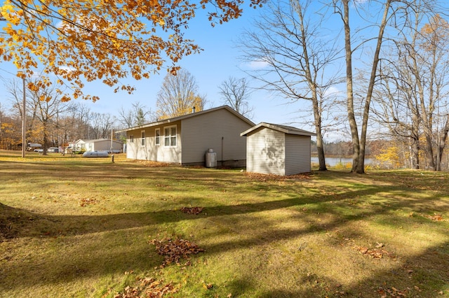 37760 310th St, Aitkin, MN 56431 - view of property exterior featuring a lawn and a storage shed