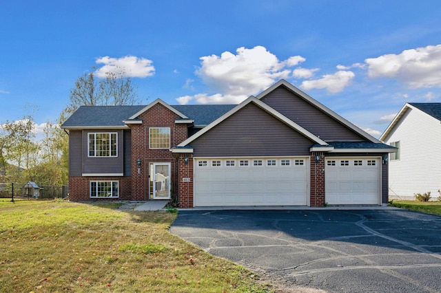 view of front of house with a front yard and a garage