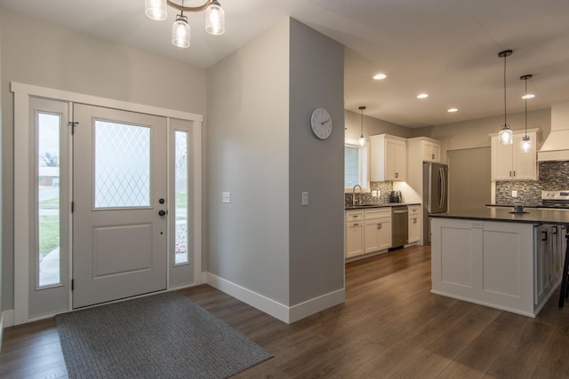 foyer with dark hardwood / wood-style flooring, a healthy amount of sunlight, and sink