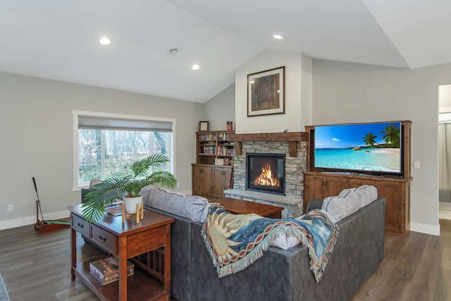 living room featuring a fireplace, vaulted ceiling, and wood-type flooring