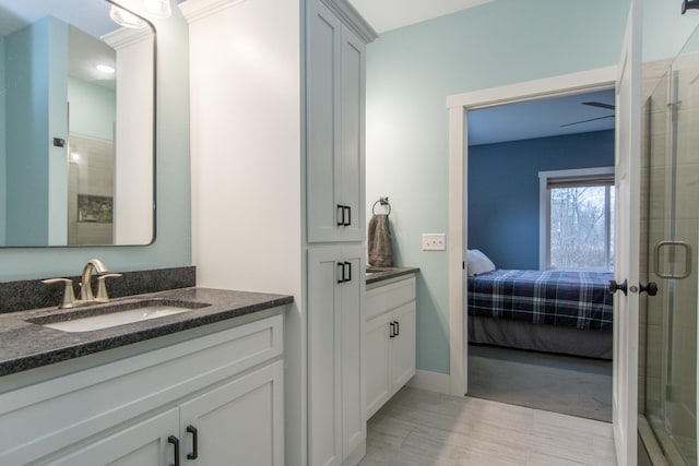 bathroom with walk in shower, vanity, and hardwood / wood-style floors