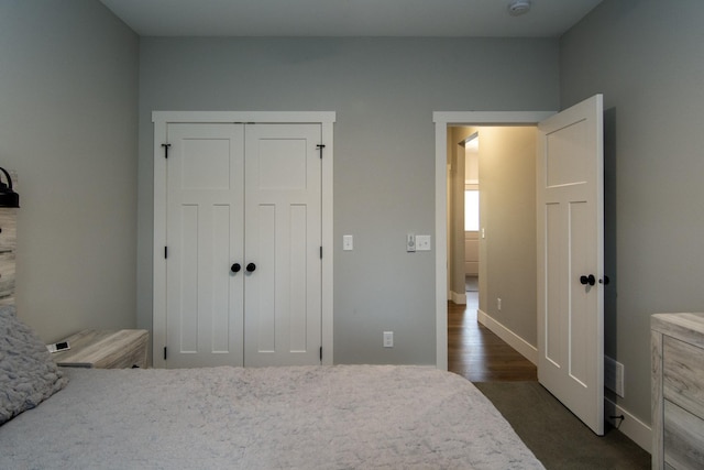 bedroom featuring dark hardwood / wood-style flooring and a closet