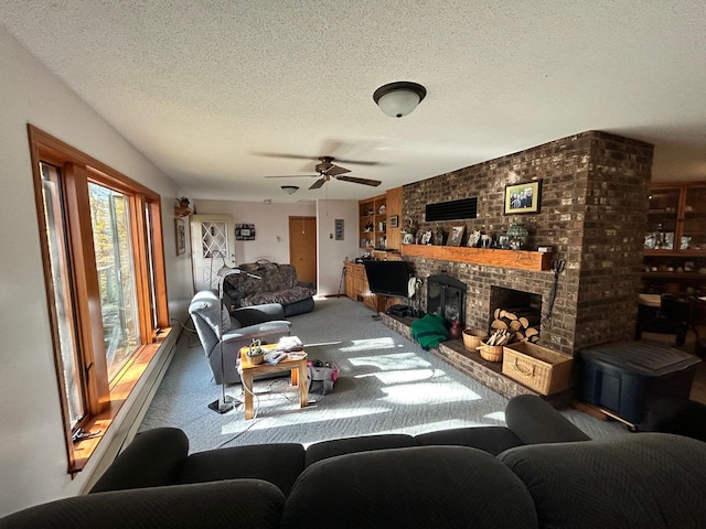 carpeted living room with a textured ceiling, a fireplace, and ceiling fan