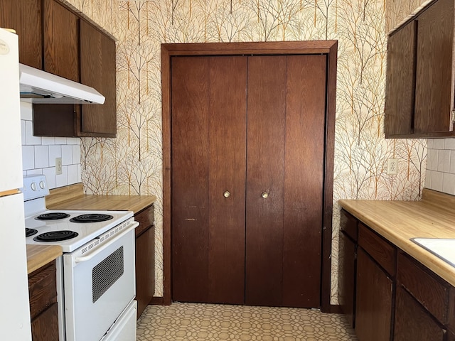 kitchen featuring white appliances, dark brown cabinets, and decorative backsplash