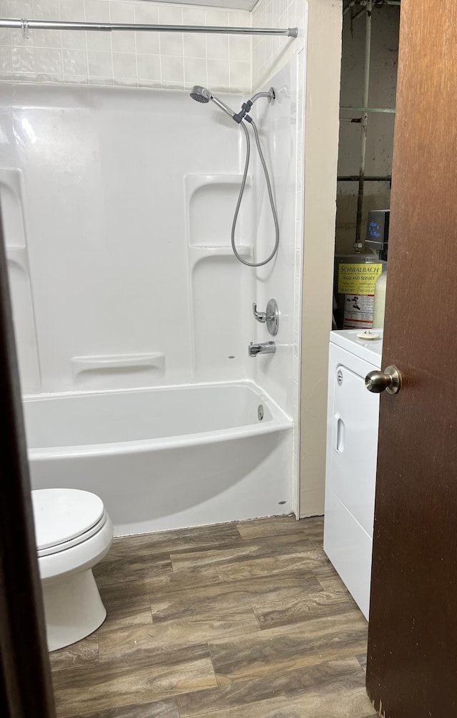 bathroom featuring shower / tub combination, wood-type flooring, toilet, and washer / clothes dryer