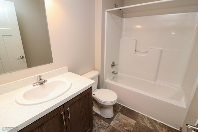 full bathroom with  shower combination, vanity, and toilet