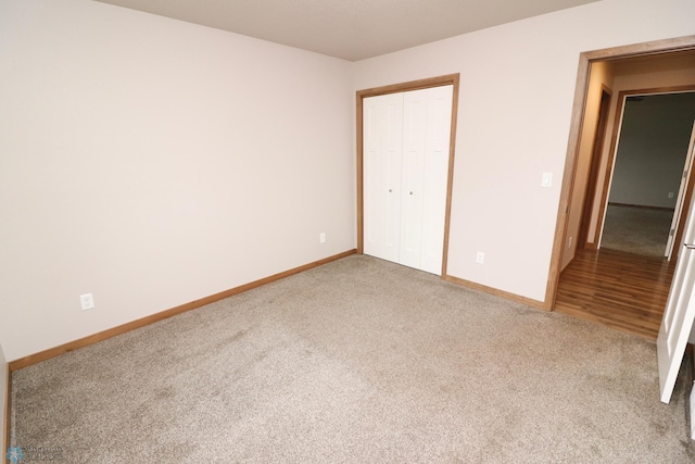 unfurnished bedroom featuring a closet and carpet floors