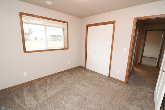 unfurnished bedroom with carpet flooring and a closet