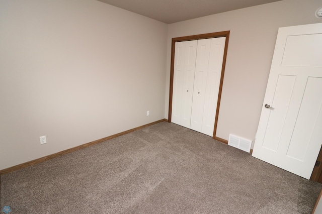 unfurnished bedroom with carpet and a closet