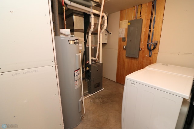 utility room featuring washing machine and dryer, electric water heater, and electric panel