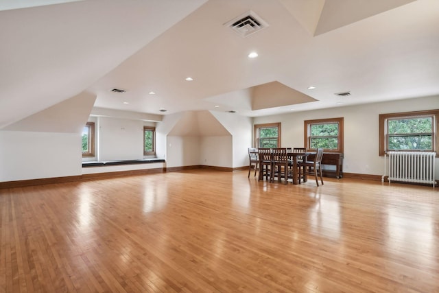 bonus room with radiator and light wood-type flooring