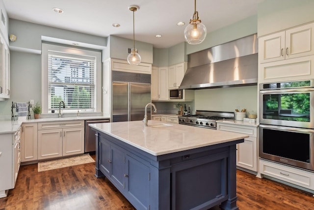 kitchen featuring appliances with stainless steel finishes, dark hardwood / wood-style floors, white cabinets, and sink