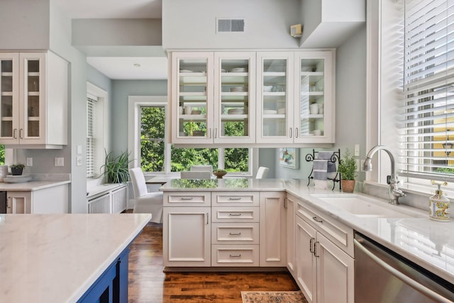 kitchen featuring white cabinets, light stone countertops, dishwasher, dark hardwood / wood-style floors, and sink