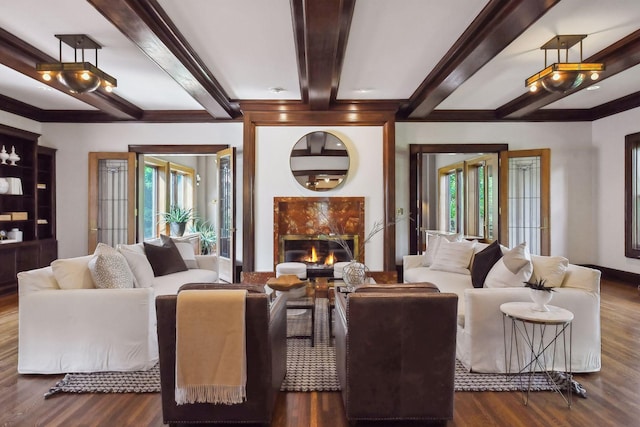 living room with a high end fireplace, beam ceiling, and dark wood-type flooring