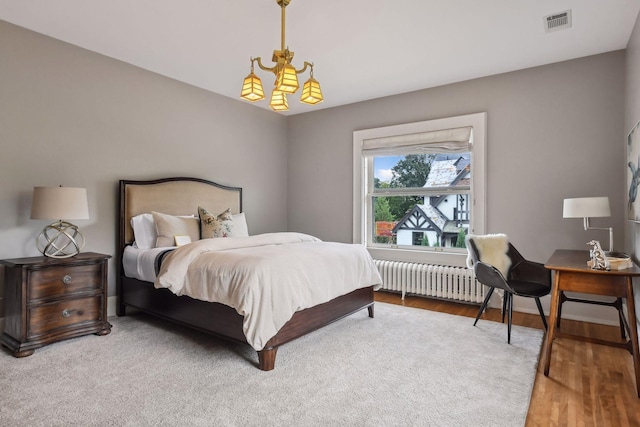 bedroom featuring wood-type flooring and radiator