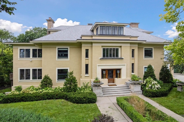 prairie-style home with a front yard and french doors