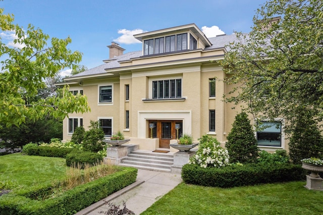 view of front of property featuring a front yard and french doors