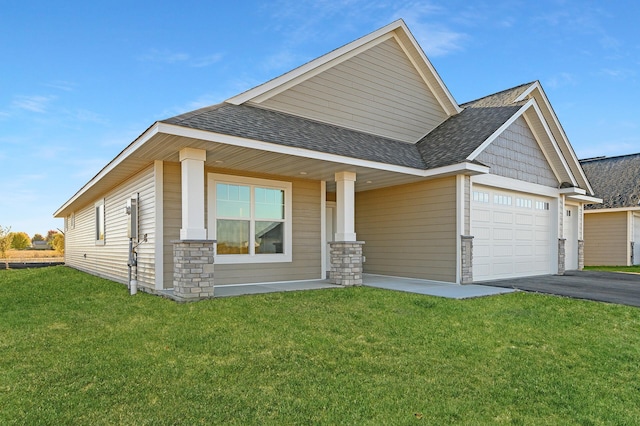 craftsman-style home with a front yard, covered porch, and a garage