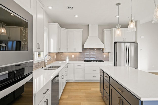 kitchen featuring black appliances, premium range hood, and white cabinets