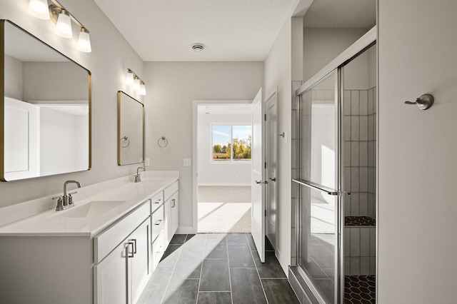 bathroom with vanity, tile patterned flooring, and a shower with door