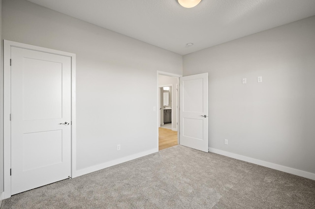 unfurnished bedroom with light carpet