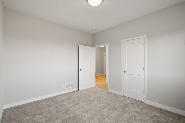 unfurnished bedroom with light colored carpet