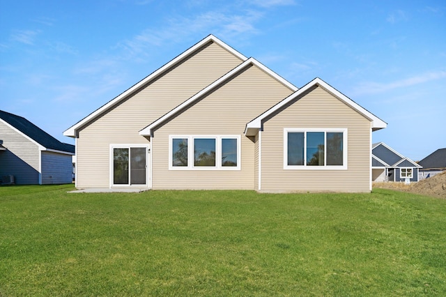 rear view of property featuring central air condition unit and a yard