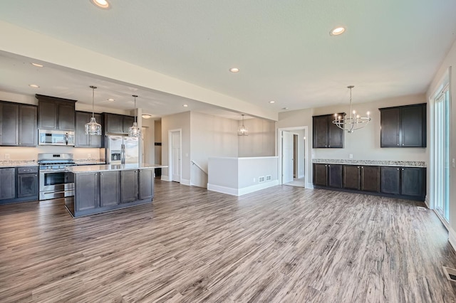 2711 Buffalo Ridge Dr, Buffalo, MN 55313 - kitchen with a notable chandelier, light countertops, appliances with stainless steel finishes, and wood finished floors