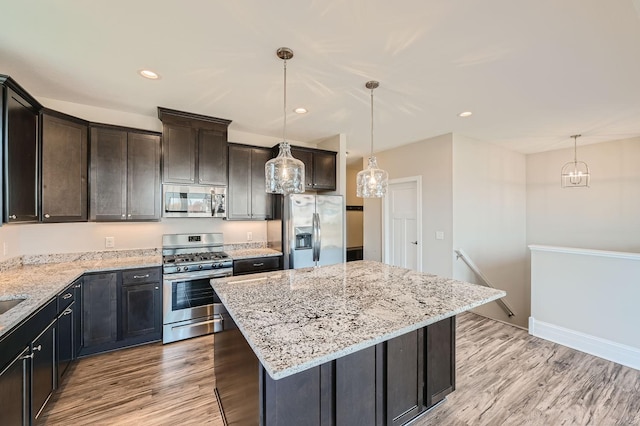 2711 Buffalo Ridge Dr, Buffalo, MN 55313 - kitchen with appliances with stainless steel finishes, light stone counters, and light wood-style floors