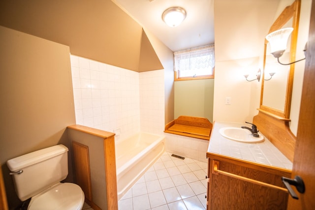 bathroom featuring tile patterned floors, vanity, toilet, and a tub to relax in