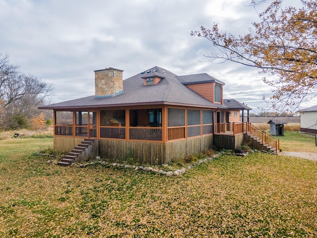 exterior space with a sunroom and a yard