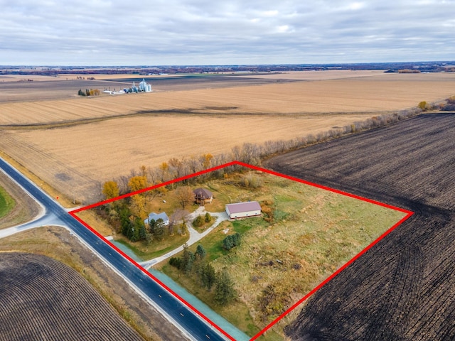 birds eye view of property with a rural view