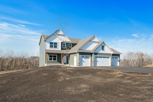 view of front of home with covered porch and a garage